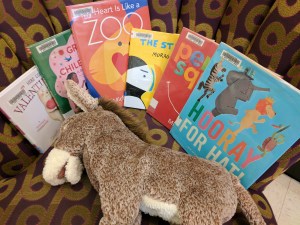 Picture books on a chair with a donkey puppet