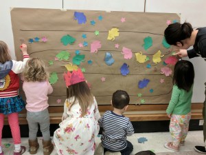 Kids gluing paper elephants and stars