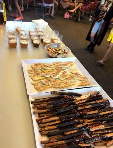 Snack table with pretzel wands, lightning bolt sugar cookies, jelly beans, and butterbeer