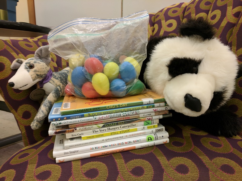 Books, shaker eggs, greyhound and panda stuffed animals