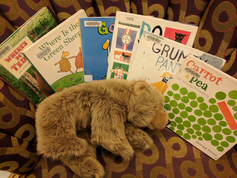 Picture books and bear on chair