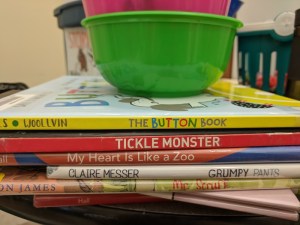 Storytime books with bowls of crayons