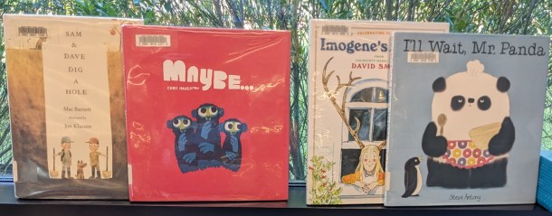 Picture books, covers out, on window ledge