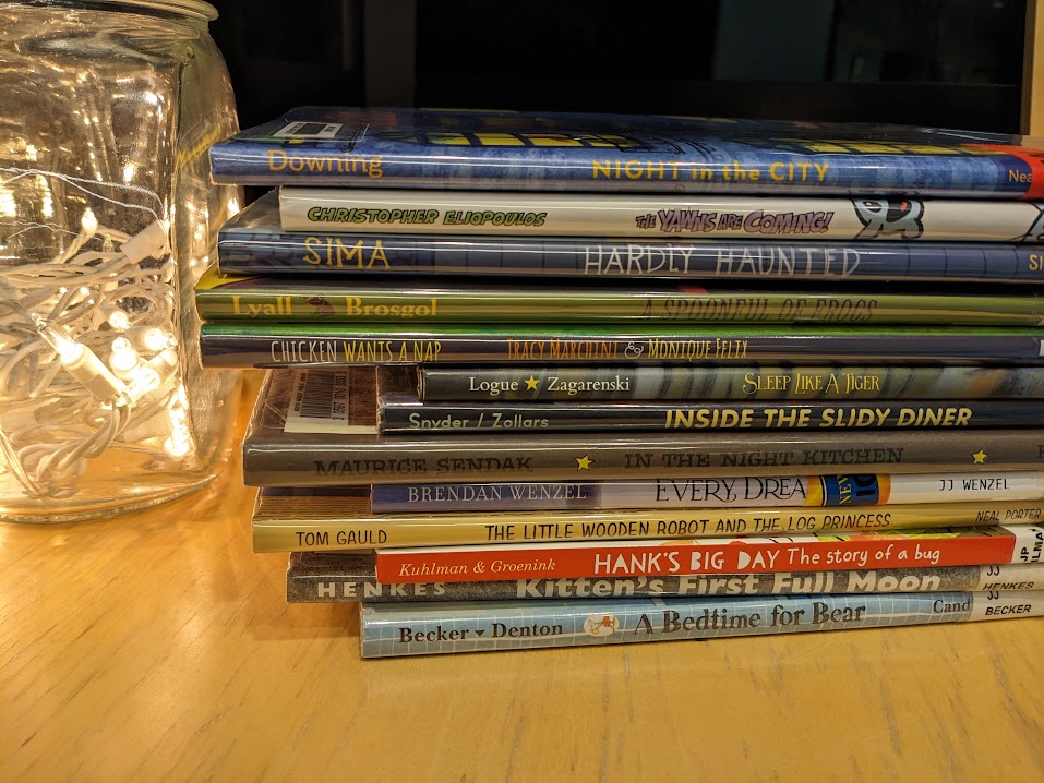 twinkle lights in a jar, a stack of books