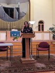 Catherine Newman standing at a podium in a church