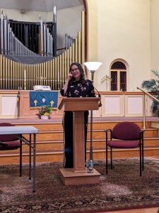 Catherine Newman standing at a podium in a church