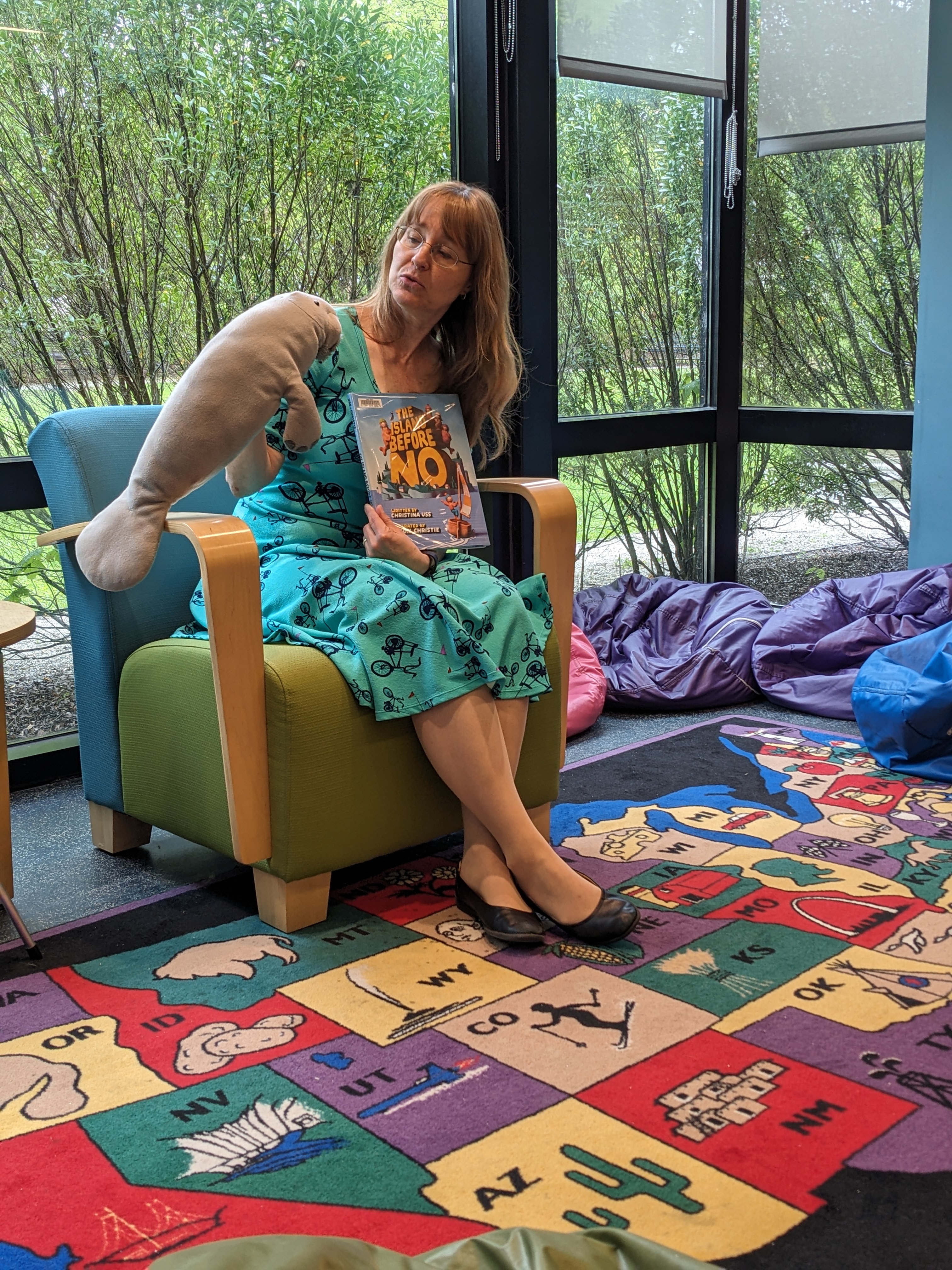 Author Christina Uss with a walrus puppet and her book, The Island Before No